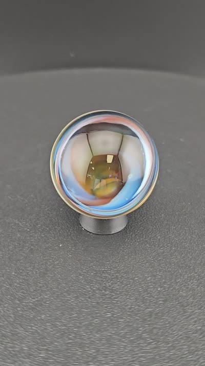 Blue and orange vortex glass marble K7